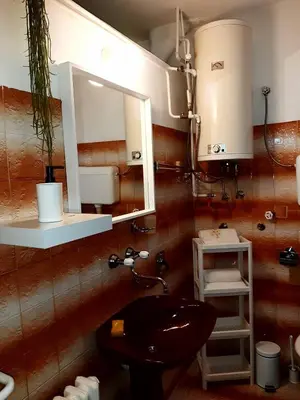 a bathroom with a sink and a mirror at Apartment Ljiljan 2 Niš in Niš