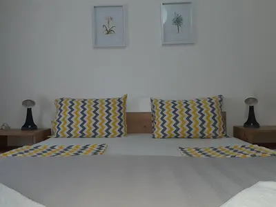 a bedroom with a bed with two pillows at Apartment Ljiljan 2 Niš in Niš