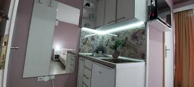 a small kitchen with a sink and a mirror at KOSA APARTMAN in Vrnjačka Banja