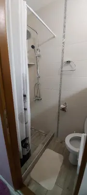 a bathroom with a shower and a toilet at KOSA APARTMAN in Vrnjačka Banja