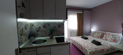 a small bathroom with a sink and a bed at KOSA APARTMAN in Vrnjačka Banja