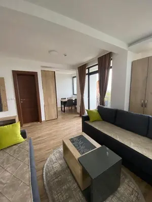 a living room with a couch and a table at Apartman LED-Treska in Kopaonik