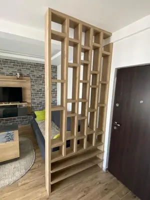 a room with a book shelf with a bed in it at Apartman LED-Treska in Kopaonik