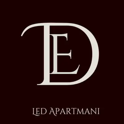 a white capital letter pt with a black background at Apartman LED-Treska in Kopaonik