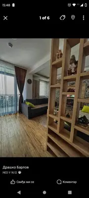 a view of a living room with a book shelf at Apartman LED-Treska in Kopaonik