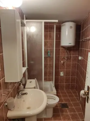 a bathroom with a toilet and a sink at AVIS Apartment in Niš