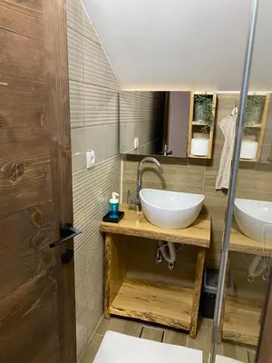 a bathroom with a sink and a mirror at Rtanjska kućica in Boljevac