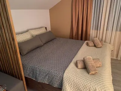 a bedroom with a bed with two pillows on it at Rtanjska kućica in Boljevac