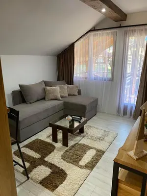 a living room with a couch and a coffee table at Rtanjska kućica in Boljevac