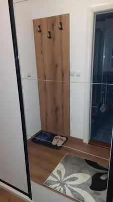 a room with a door and a pair of sandals on the floor at Apartman 109 Vila Nikola in Kopaonik
