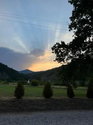 a view of a field with a sunset in the background at Domus in natura in Cerovak