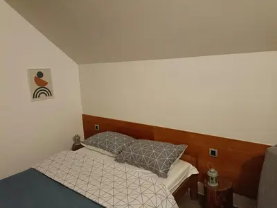a small bed with two pillows on it in a room at Domus in natura in Cerovak