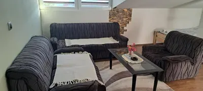 a living room with two couches and a coffee table at Apartman Studio AGAPE in Vrnjačka Banja