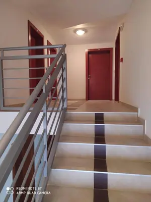 a staircase in a building with a red door at Apartman Studio AGAPE in Vrnjačka Banja