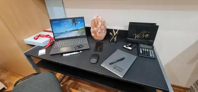 a desk with a laptop computer and other items on it at Design Apartment BUSINESS LUX 4 STAR 