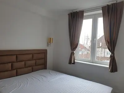 a bedroom with a bed and a window at Apartman Sofy Kraljevi Čardaci in Kopaonik