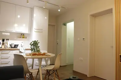 a kitchen and dining room with a table and chairs at Vista Apartmani in Ribarska Banja