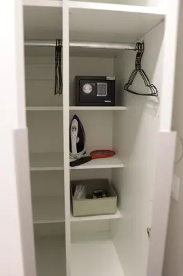 a book shelf with a microwave and a radio on it at Vista Apartmani in Ribarska Banja