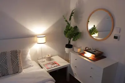a bedroom with a bed and a dresser with a mirror at Vista Apartmani in Ribarska Banja