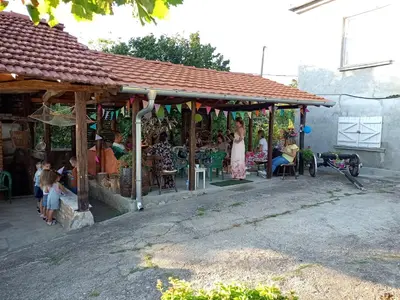 a group of people sitting at a store in a building at House Seoska OAZA in Crnoklište