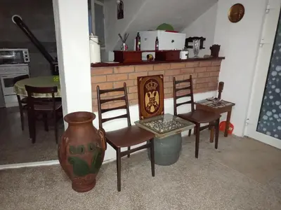 a living room with chairs and a fireplace at House Seoska OAZA in Crnoklište