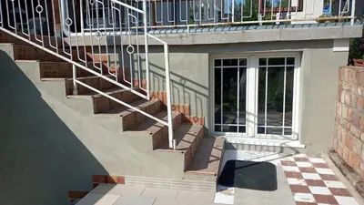 a stairway leading up to a building with a staircase at House Seoska OAZA in Crnoklište