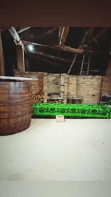 a room with two wooden barrels and a green wall at House Seoska OAZA in Crnoklište