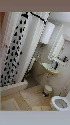 a bathroom with a sink and a toilet and a staircase at House Seoska OAZA in Crnoklište