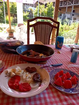 a table with plates of food on a table at House Seoska OAZA in Crnoklište