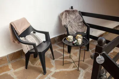 a room with two chairs and a table with candles at Apartman TALIJA in Pirot