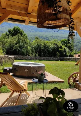 a patio with a table and chairs and a fountain at Apartman TALIJA in Pirot