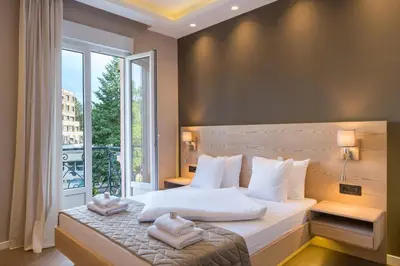 a bedroom with a bed with two towels on it at Emilia Lux Rooms in Vrnjačka Banja
