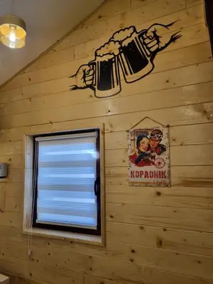 a wall with a window with two beer signs at Garnet Star Apartments, Kopaonik, apartman broj 4 in Kopaonik