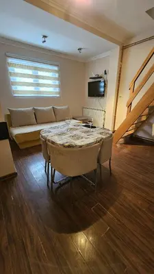 a living room with a couch and a table at Apartman 202 in Kopaonik