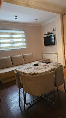 a living room with a table and a couch at Apartman 202 in Kopaonik