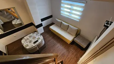 a living room with a couch and a window at Apartman 202 in Kopaonik