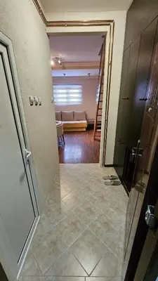 a hallway with a living room with a couch at Apartman 202 in Kopaonik