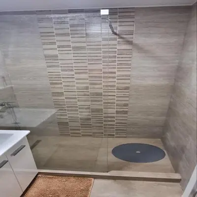 a shower with a glass door in a bathroom at Iznad oblaka B09 in Kopaonik