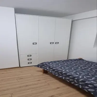 a bedroom with white cabinets and a bed at Iznad oblaka B09 in Kopaonik