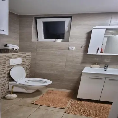 a bathroom with a toilet and a sink and a tv at Iznad oblaka B09 in Kopaonik
