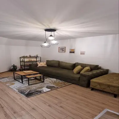 a living room with a couch and a table at Iznad oblaka B09 in Kopaonik