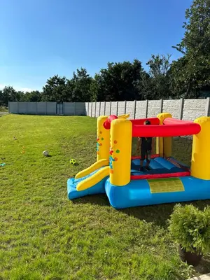 a child is playing in a play set in a yard at Mi Casa in Brestovac