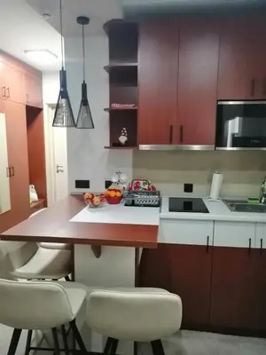 a kitchen with a table with chairs and a counter top at Tina Kop Apartments, Kopaonik in Kopaonik