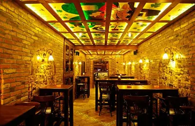 a room with tables and chairs in a restaurant at Apartmani BOŠ in Cajetina