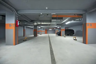 an empty parking garage with a van parked in it at Apartmani BOŠ in Cajetina
