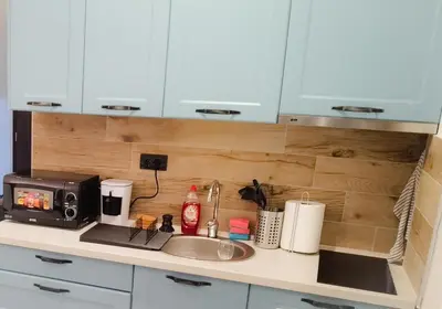 a kitchen counter with a sink and a microwave at Apartman Rastko-N Lux 32 Milmari in Kopaonik