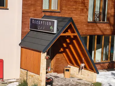 a dog house in front of a building at Apartman Rastko-N Lux 32 Milmari in Kopaonik