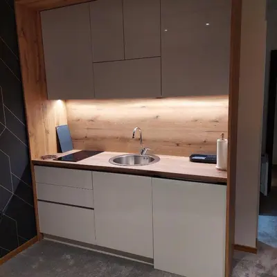 a kitchen counter with a sink and a mirror at Nela apartmani (u hotelu Djina) in Kopaonik