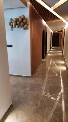 a hallway with a white refrigerator in a room at Nela apartmani (u hotelu Djina) in Kopaonik
