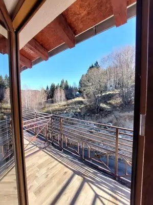 a view of a bridge from a window at Apartman Mile High -N Lux 90a Milmari Kopaonik in Kopaonik